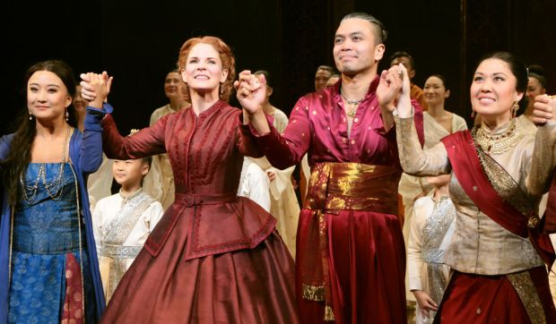 Group of actors holding hands about to bow during a curtain call