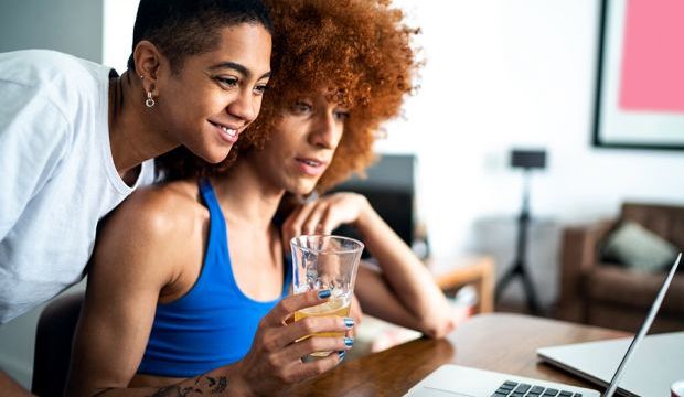 Two women looking at the same computer screen