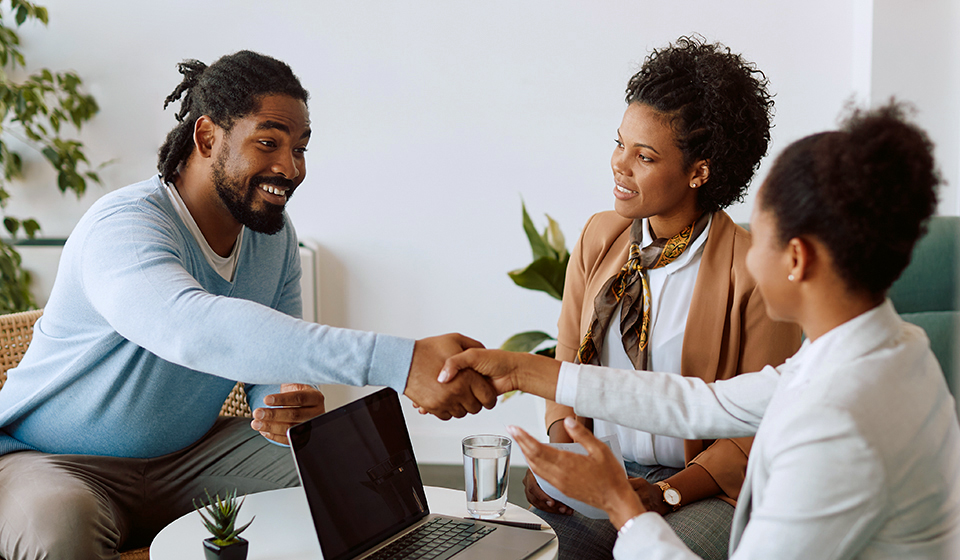 A job candidate shakes hands with an interviewer