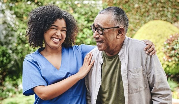 A nurse helping an older man